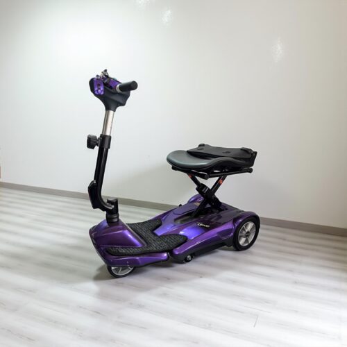 Photo showing a three-quarter view of the left side and front of a Purple, Drive Autofold Dual Wheel Second hand mobility scooter.