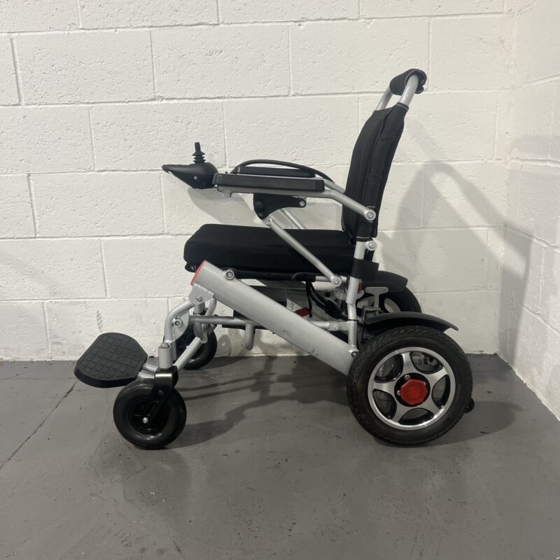 Left Hand Side View of a Silver Second-hand Class 2 Transportable Light-weight Foldable Majestic Buvan Powered Wheelchair Majestic Buvan Powerchair