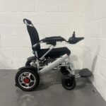 Right Hand Side View of a Silver Second-hand Class 2 Transportable Light-weight Foldable Majestic Buvan Powered Wheelchair Majestic Buvan Powerchair