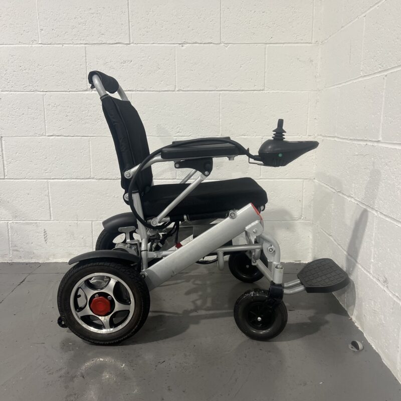 Right Hand Side View of a Silver Second-hand Class 2 Transportable Light-weight Foldable Majestic Buvan Powered Wheelchair Majestic Buvan Powerchair