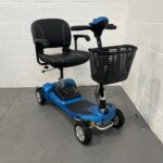 Front and Right Side Perspective of a Li-tech Neon 15 Mobility Scooter. the Scooter Features a Vibrant Blue Body with Black Accents, Including a Padded, Black Leatherette Adjustable Swivel Seat with Armrests and Stitching Details. It Has a Spacious Black Wire Basket Attached to the Blue Tiller. the Front Wheel Has Visible Yellow Suspension Springs, and the Scooter is Equipped with Solid Black Tires on Silver Rims. Li-tech Neon 15