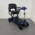Three-quarter View of the Right and Front of a Second-hand Blue Optimus Automatic Folding Mobility Scooter. Optimus Automatic Folding Scooter