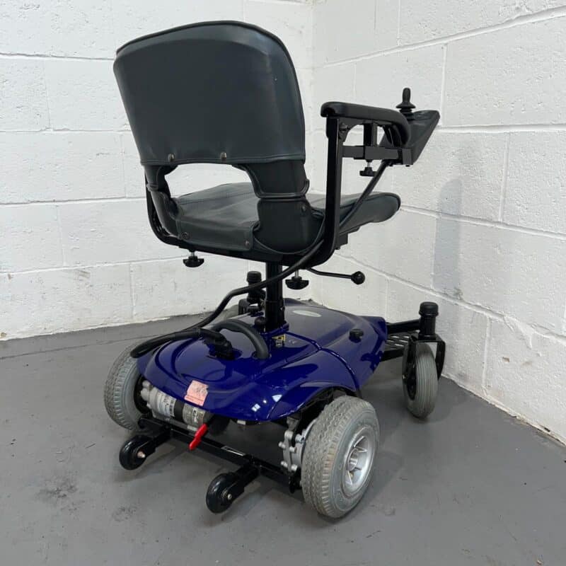Photo Showing a Three-quarter View of the Right Side and Rear of a Used, Blue and Black Careco Fenix Second-hand Powerchair. Careco Fenix Powerchair