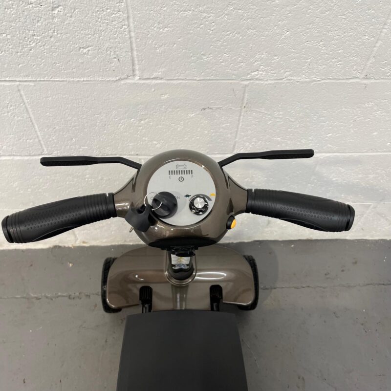the Controls of a Second-hand Gold and Black Globe Trotter Edrive Automatic Folding Mobility Scooter. One Rehab Globetrotter