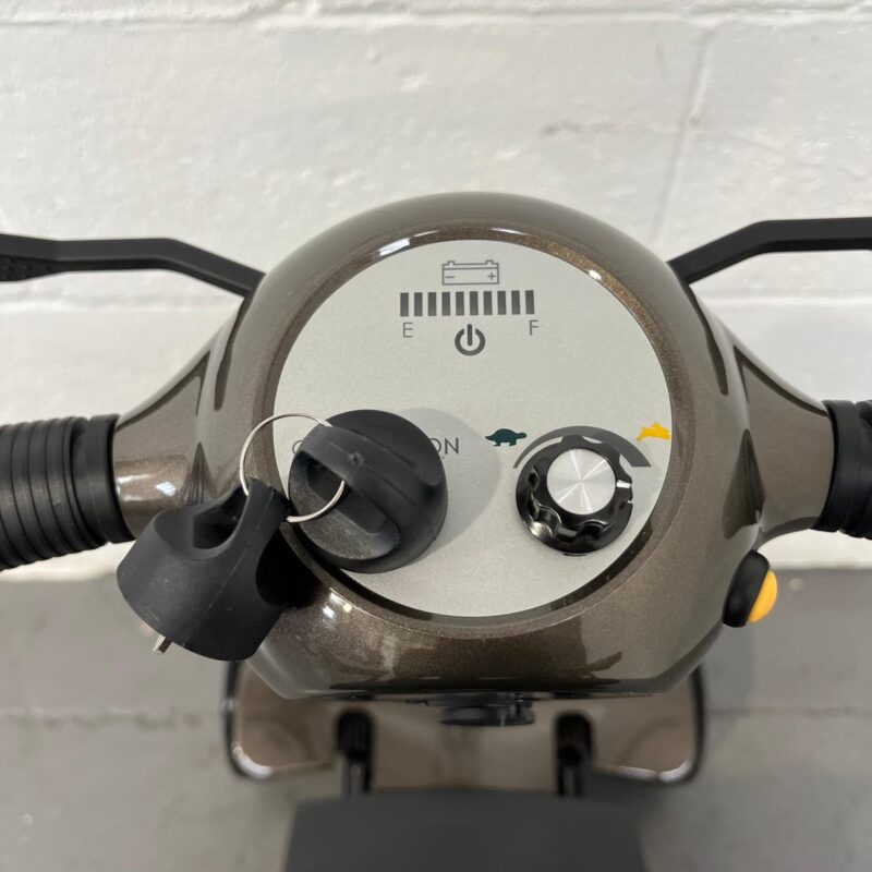 a Close-up of the Control Panel of a Second-hand Gold and Black Globe Trotter Edrive Automatic Folding Mobility Scooter. One Rehab Globetrotter