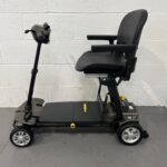 a View of the Left Side of a Second-hand Gold and Black Globe Trotter Edrive Automatic Folding Mobility Scooter. One Rehab Globetrotter