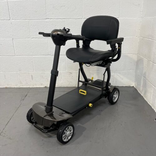 a Three Quarter View of the Front and Left Side of a Second-hand Gold and Black Globe Trotter Edrive Automatic Folding Mobility Scooter. Contact