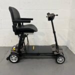 a View of the Right Side of a Second-hand Gold and Black Globe Trotter Edrive Automatic Folding Mobility Scooter. One Rehab Globetrotter