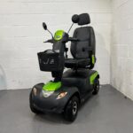 Three-quarter View of the Left Side and Front of a Green and Black, 8mph, Road-legal, Second-hand Invacare Comet Pro Mobility Scooter. Invacare Comet Pro