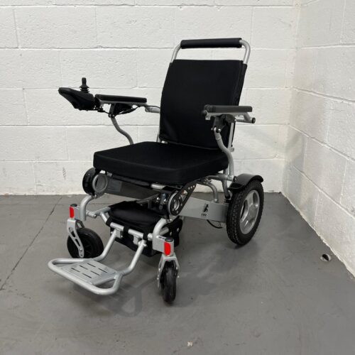 Three-quarter view of left side and front of a second-hand silver and black KWK D09 Powerchair.