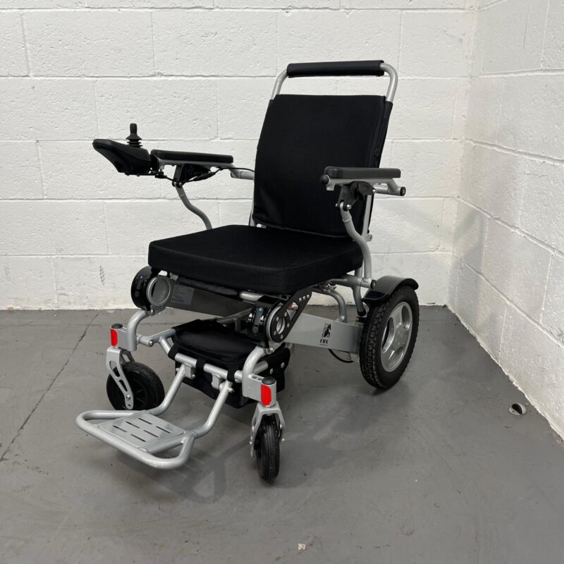 Three-quarter View of Left Side and Front of a Second-hand Silver and Black Kwk D09 Powerchair. Kwk D09 Powerchair