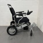 Right Side View of a Second-hand Silver and Black Kwk D09 Powerchair. Kwk D09 Powerchair