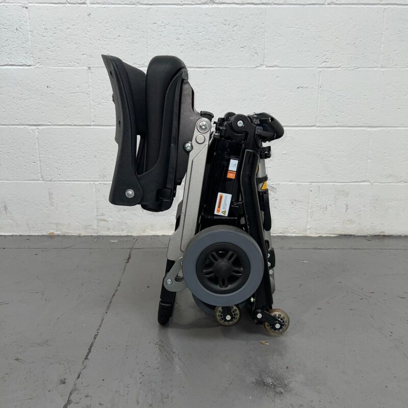 View of the Side of a Black 4mph Lightweight Folding Second-hand Luggie Mobility Scooter. Luggie Standard