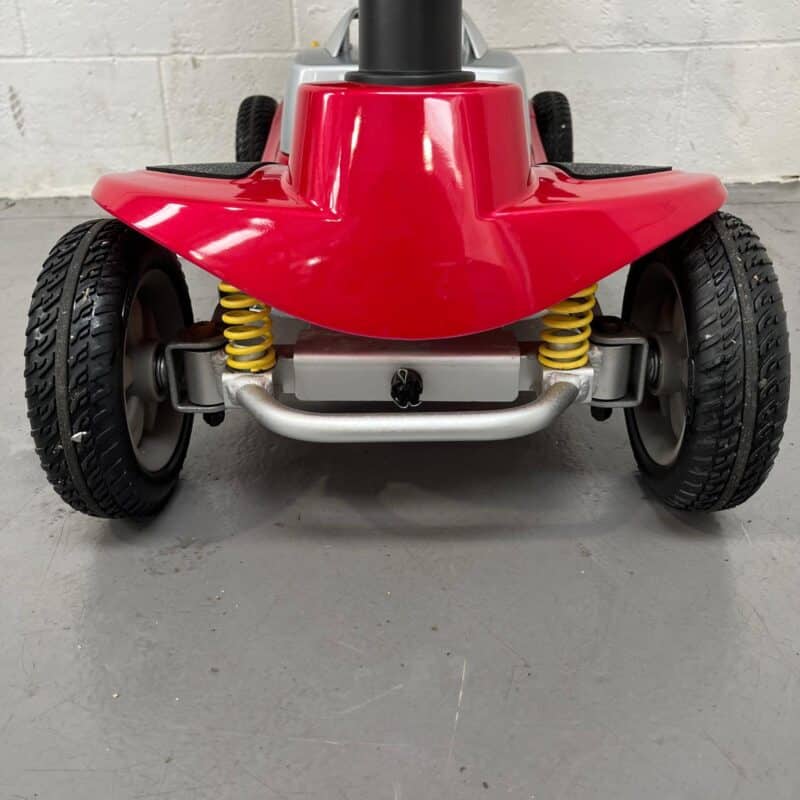 Close-up View of the Front of a Second-hand Red One Rehab Illusion Transportable Mobility Scooter. It Shows the Front Bumber and Suspension. One Rehab Illusion (red)