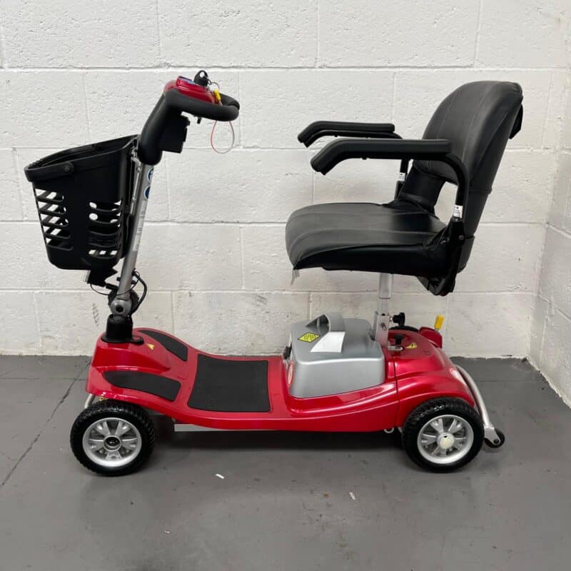 View of the Left-hand Side of a Second-hand Red One Rehab Illusion Transportable Mobility Scooter. One Rehab Illusion (red)