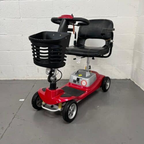 Three-quarter View of the Left and Front of a Second-hand Red One Rehab Illusion Transportable Mobility Scooter. Returns Policy