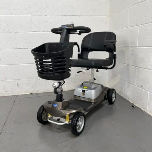 Photo showing three-quarter view of the left side and front of a used bronze and black One Rehab Illusion second-hand mobility scooter.