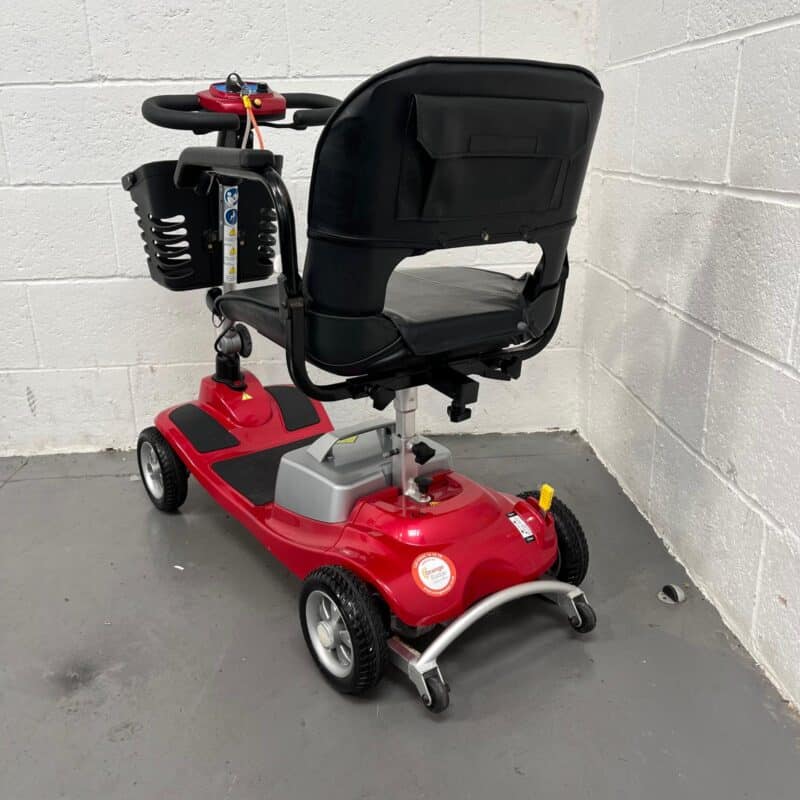 Three-quarter View of the Left and Rear of a Second-hand Red One Rehab Illusion Transportable Mobility Scooter. One Rehab Illusion (red)