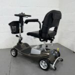 Photo Showing Three-quarter View of the Left Side and Rear of a Used Bronze and Black One Rehab Illusion Second-hand Mobility Scooter. One Rehab Illusion