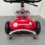 Closeup View of the Stability Wheels, Handbrake and Suspension at the Rear of a Second-hand Red One Rehab Illusion Transportable Mobility Scooter. One Rehab Illusion (red)