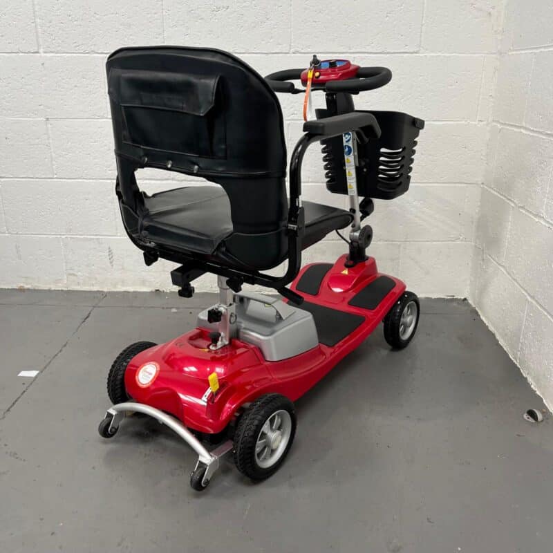Three-quarter View of the Right and Rear of a Second-hand Red One Rehab Illusion Transportable Mobility Scooter. One Rehab Illusion (red)