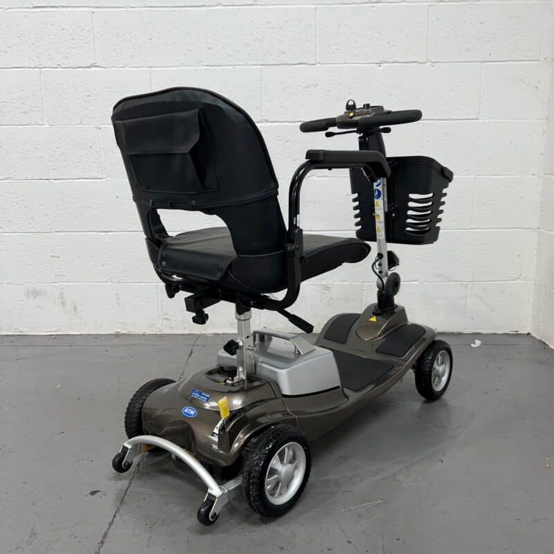 Photo Showing Three-quarter View of the Right Side and Rear of a Used Bronze and Black One Rehab Illusion Second-hand Mobility Scooter. One Rehab Illusion