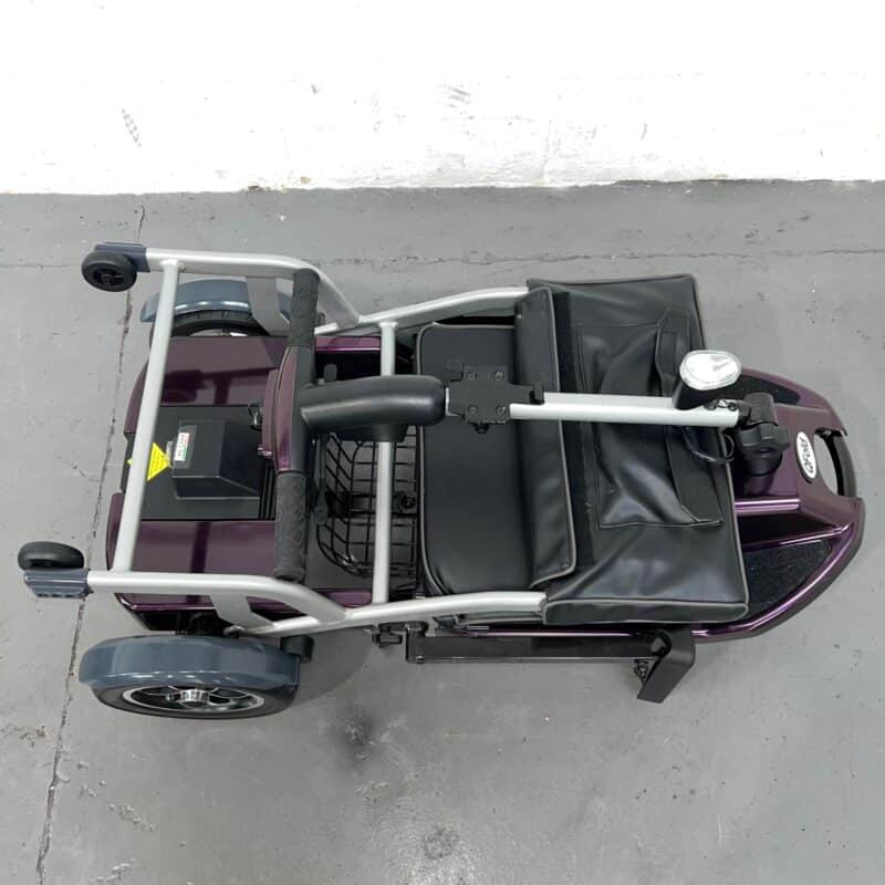 Top-down View of a Folded Purple 4mph Folding Second-hand One Rehab Q Fold Mobility Scooter. One Rehab Q Fold