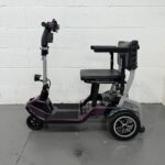 View of the Left Side of a Purple 4mph Folding Second-hand One Rehab Q Fold Mobility Scooter. One Rehab Q Fold