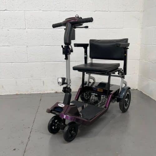 Three Quarter View of the Left Side and Front of a Purple 4mph Folding Second-hand One Rehab Q Fold Mobility Scooter. Used Mobility Scooter Shop | Second Hand Mobility Scooters!