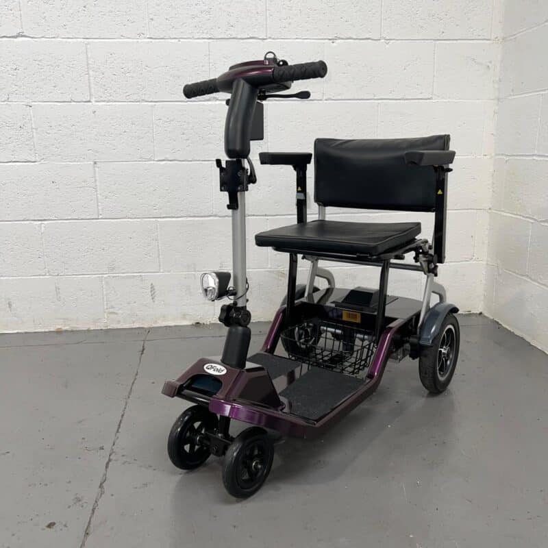 Three Quarter View of the Left Side and Front of a Purple 4mph Folding Second-hand One Rehab Q Fold Mobility Scooter. One Rehab Q Fold