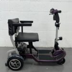 View of the Right Side of a Purple 4mph Folding Second-hand One Rehab Q Fold Mobility Scooter. One Rehab Q Fold