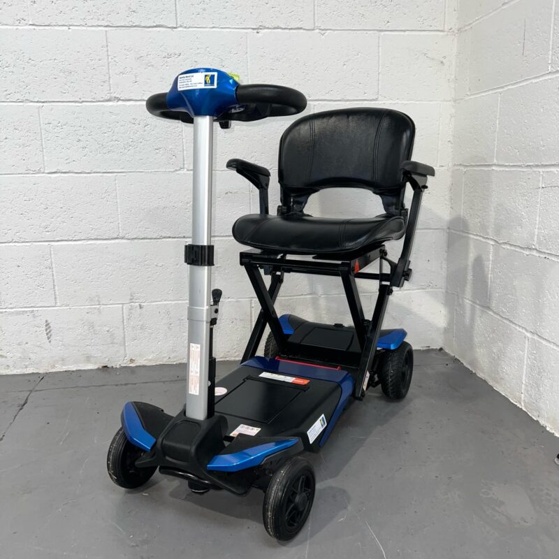 Three-quarter View of the Left Side and Front of a Blue 4mph Automatic Folding Second-hand Solax Autofold Mobility Scooter. Solax Autofold (blue)