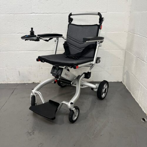 Photo showing a three-quarter view of the left side and front of a silver and black Aerolite second-hand powered wheelchair.