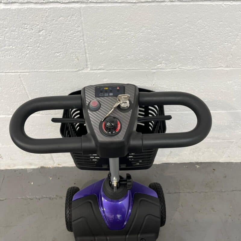 Photo of the Controls and Handlebars on a Purple and Black, Motion Healthcare Evolite Second-hand Mobility Scooter. Motion Healthcare Evolite