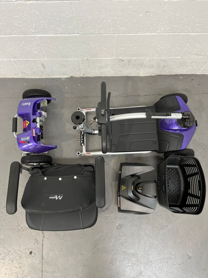 Photo of a Purple and Black, Motion Healthcare Evolite Second-hand Mobility Scooter, Deconstructed into 5 Parts for Easy Transportation. Motion Healthcare Evolite