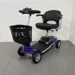 Photo Showing a Three-quarter View of the Left Side and Front of a Purple and Black, Motion Healthcare Evolite Second-hand Mobility Scooter. Motion Healthcare Evolite