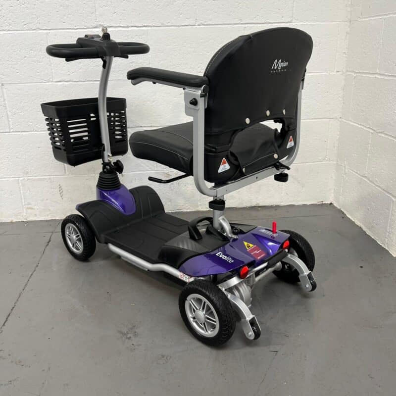 Photo Showing a Three-quarter View of the Left Side and Rear of a Purple and Black, Motion Healthcare Evolite Second-hand Mobility Scooter. Motion Healthcare Evolite