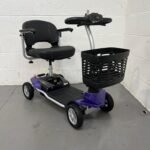 Photo Showing a Three-quarter View of the Right Side and Front of a Purple and Black, Motion Healthcare Evolite Second-hand Mobility Scooter. Motion Healthcare Evolite