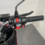 Photo Showing a Close-up on the Right-hand Side of the Handlebars on a Dark Red, Greenpower Unique 500 Second-hand Mobility Scooter. Greenpower Unique 500
