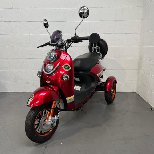 Photo showing a three-quarter view of the left side and front of a dark red, GreenPower Unique 500 second-hand mobility scooter.