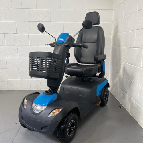 Photo Showing a Three-quarter View of the Left Side and Front of a Blue and Dark Grey, Invacare Comet Pro Second-hand Mobility Scooter. Used Mobility Scooter Shop | Second Hand Mobility Scooters!