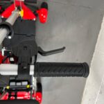 Photo Showing a Close-up of Accellerator Lever on the Right Handlebar of a Red and Black, Motion Healthcare Mlite Second-hand Mobility Scooter. Motion Healthcare Mlite