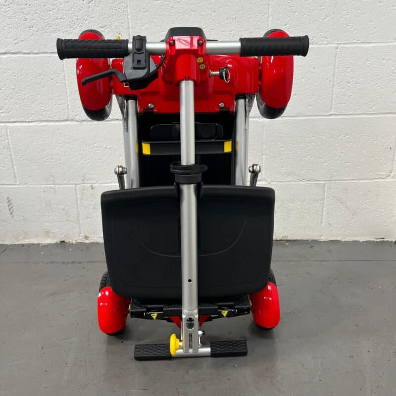 Photo of the Front of a Folded Red and Black, Motion Healthcare Mlite Second-hand Mobility Scooter. Motion Healthcare Mlite