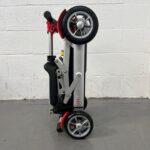 Photo of the Side of a Folded Red and Black, Motion Healthcare Mlite Second-hand Mobility Scooter. Motion Healthcare Mlite