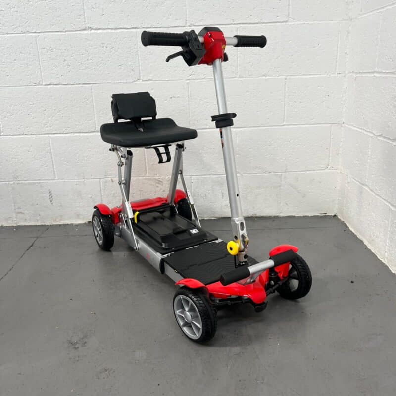 Photo Showing a Three-quarter View of the Right Side and Front of a Red and Black, Motion Healthcare Mlite Second-hand Mobility Scooter. Motion Healthcare Mlite