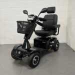 Photo Showing a Three-quarter View of the Left Side and Front of a Black Stirling S700 Second-hand Mobility Scooter. Sunrise Medical Sterling S700