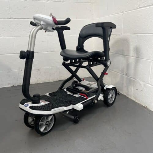 Photo showing a three-quarter view of the left side and front of a white and black TGA Minimo second-hand mobility scooter.