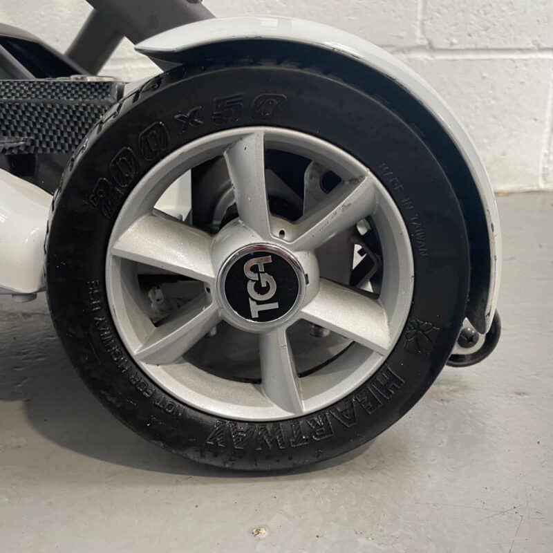 Photo of the Rear Wheel on a White and Black Tga Minimo Second-hand Mobility Scooter. Tga Minimo